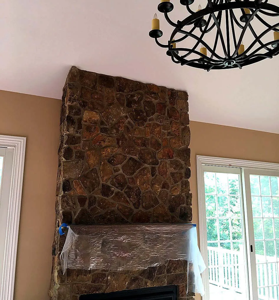 Great room with stone chimney and warm tan walls