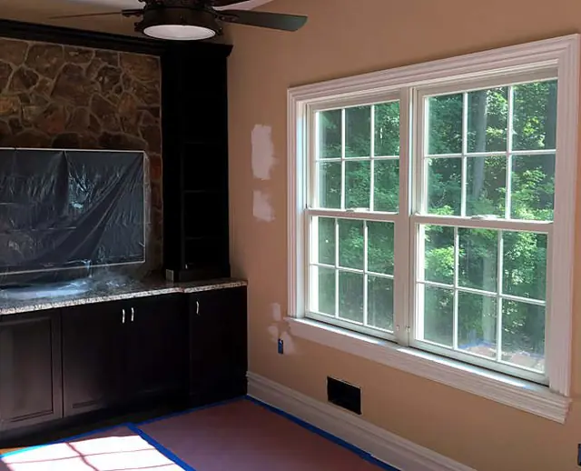 Stone, trim, and a warm field — Two-story opening
