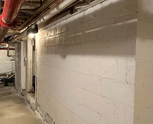 Block, piers, and a tall wall — Foundation block coated white